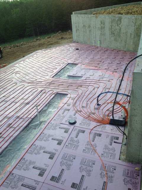 Radiant floor heating tubing laid on slab insulation before the concrete pour